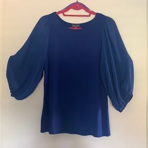 Dressy royal blue blouse with chiffon sleeves.
